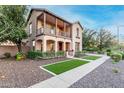 Beautiful home with a charming front yard, balcony, and well-maintained landscaping at 15289 W Valentine St, Surprise, AZ 85379