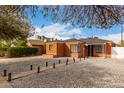 Beautiful brick home featuring a unique rock yard, charming pathway, and modern architectural details at 1810 N 12Th St, Phoenix, AZ 85006