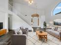 Bright living room featuring a soaring ceiling, modern furnishings, and a staircase at 1940 W Oriole Way, Chandler, AZ 85286