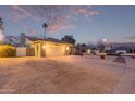 Street view of home with gravel front yard and a two-car garage at dusk at 2248 W Mandalay Ln, Phoenix, AZ 85023