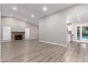 Spacious living room featuring a brick fireplace, recessed lighting, and wood-look floors at 2248 W Mandalay Ln, Phoenix, AZ 85023