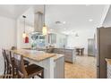 Bright, open kitchen featuring granite countertops, stainless steel appliances, pendant lighting, and an island at 2346 E Lupine Ave, Phoenix, AZ 85028