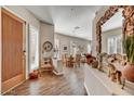 Inviting foyer with wood floors, elegant decor, and plenty of natural light streaming through plantation-shuttered windows at 26560 N 115Th St, Scottsdale, AZ 85255