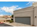 Charming single story home featuring a gray garage door, and manicured landscaping at 295 N Rural Rd # 151, Chandler, AZ 85226