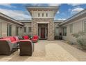 Private front courtyard with outdoor seating area, stone accents and inviting entry to the home at 3425 E Birchwood Pl, Chandler, AZ 85249