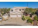 Aerial view showcasing a two-story home with a three-car garage and lush landscaping at 3524 E Derringer Way, Gilbert, AZ 85297