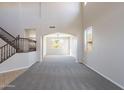 Open living space with high ceilings, a staircase, and arched doorway at 3524 E Derringer Way, Gilbert, AZ 85297