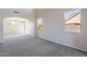 Bright living room with fresh gray carpet, neutral walls, and ample natural light at 3524 E Derringer Way, Gilbert, AZ 85297