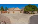 Single-Gathering home featuring three-car garage, wide driveway, desert landscaping, and secured RV parking at 3562 E Harvard Ct, Gilbert, AZ 85234