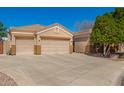 Single-Gathering home featuring three-car garage, wide driveway, desert landscaping, and secured RV parking at 3562 E Harvard Ct, Gilbert, AZ 85234