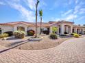 Inviting single-story house with desert landscaping, a brick driveway, and an arched entryway at 3943 E Omega Cir, Mesa, AZ 85215