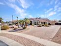 Beautiful single-story home with desert landscaping, a brick driveway, and a red tile roof at 3943 E Omega Cir, Mesa, AZ 85215