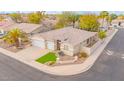 Aesthetic aerial view of a well-landscaped home boasting a three-car garage, sidewalk, and a cozy, inviting facade at 44 W Teakwood Pl, Chandler, AZ 85248