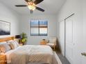 Well-lit main bedroom with a neutral palette, carpet flooring, and an ample closet at 45997 W Windmill Dr, Maricopa, AZ 85139