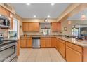 Spacious kitchen with stainless steel appliances, granite countertops, and tile flooring at 4720 E Flossmoor Cir, Mesa, AZ 85206