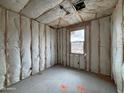 New construction bedroom with wall and ceiling insulation before drywall is installed, creating a blank slate at 47734 W Kenner Dr, Maricopa, AZ 85139