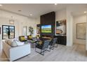 Comfortable living room featuring a fireplace, flat screen television, and stylish seating arrangement at 510 E Woburn Ln, Phoenix, AZ 85085