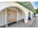 Arched entryway featuring a decorative metal security door, offering both security and curb appeal at 5501 E Camelback Rd, Phoenix, AZ 85018