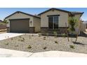 Well-maintained home with a two-car garage and drought-tolerant front yard at 5508 N 192Nd Ave, Litchfield Park, AZ 85340