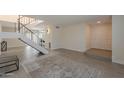 Open living area with tile floors, neutral tones, modern staircase, and recessed lighting at 5853 E Thomas Rd, Scottsdale, AZ 85251