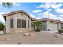 Charming home with desert landscaping, showcasing low-maintenance yard at 70 S Laura Ln, Casa Grande, AZ 85194