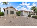 Exterior view of a single-story home, showing desert landscaping at 70 S Laura Ln, Casa Grande, AZ 85194