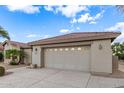 Attached two-car garage featuring a neutral color scheme and a decorative driveway at 70 S Laura Ln, Casa Grande, AZ 85194