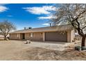 Ranch-style home with neutral paint, a two-car garage, and a desert landscape at 8431 W Planada Ln, Peoria, AZ 85383