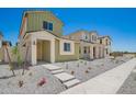 The two-story home has a charming facade with clean landscaping and neutral tones, set in a well-planned neighborhood at 15610 S 181St Dr, Goodyear, AZ 85338