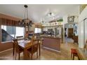 Well-lit kitchen featuring stainless steel appliances, a center island and an adjacent dining area at 16424 N 1St Dr, Phoenix, AZ 85023