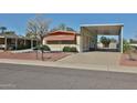 Charming desert home featuring covered parking, low-maintenance rock landscaping and mature shade tree at 17244 N 66Th Ln, Glendale, AZ 85308