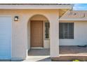 Inviting front entrance with a arched entryway, and a lovely wood door at 17631 N 42Nd Dr, Glendale, AZ 85308