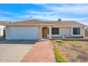 Charming single-story home featuring a well-manicured lawn, neutral colors and a two-car garage at 17631 N 42Nd Dr, Glendale, AZ 85308