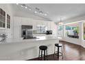 Bright kitchen featuring stainless steel appliances, white cabinets and a center island with bar stool seating at 17631 N 42Nd Dr, Glendale, AZ 85308