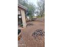 Spacious backyard showing a partial view of the house and some equipment and tools at 18293 W Elm St, Surprise, AZ 85388