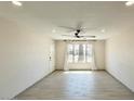 Bright living room featuring wood-look tile flooring, a ceiling fan, and ample natural light at 1946 E Wesleyan Dr, Tempe, AZ 85282