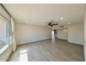 Spacious living room with wood-look tile floors, neutral paint, and lots of natural light at 1946 E Wesleyan Dr, Tempe, AZ 85282
