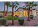 Secluded backyard with artificial turf, mature landscaping, and a partial view of the home's exterior at 21008 W Cora Vis, Buckeye, AZ 85396