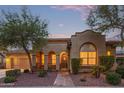 Charming single-story home with desert landscaping and a brick walkway leading to the arched entrance at 21008 W Cora Vis, Buckeye, AZ 85396