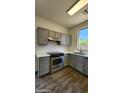 Updated kitchen features modern appliances, gray cabinets and white countertops at 2143 N 30Th St, Mesa, AZ 85213