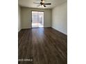 Well lit living room with a sliding glass door and dark wood flooring at 2143 N 30Th St, Mesa, AZ 85213