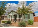 Inviting single-story home with desert landscaping, offering a warm and welcoming curb appeal on a partly cloudy day at 22552 E Via Estancia --, Queen Creek, AZ 85142