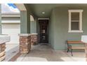 Welcoming front porch with stone accents, a seating bench, and a stylish secure door, enhancing the home's curb appeal at 22552 E Via Estancia --, Queen Creek, AZ 85142
