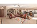 Open-concept living room featuring tile floors, archways, and plenty of seating at 2325 W Mineral Rd, Phoenix, AZ 85041