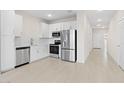 Contemporary kitchen boasting stainless steel appliances, white cabinetry, and a functional layout open to the living area at 2832 W Eagle Talon Rd, Phoenix, AZ 85085