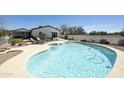 Sparkling pool with rock landscaping and poolside chairs, ideal for relaxation at 33810 N Smokehouse Trl, Cave Creek, AZ 85331