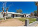 Exterior view of home with a compact yard and desert landscaping at 3422 W Sells Dr, Phoenix, AZ 85017