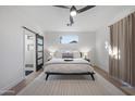 Serene main bedroom with a king-sized bed, soft lighting, and a sliding barn door to the bathroom at 362 N Roger Way, Chandler, AZ 85225