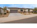 A cozy single-story house with a two-car garage, long driveway, and low maintenance yard at 39758 N Hailey Ln, Queen Creek, AZ 85140