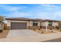 A cozy single-story house with a two-car garage and a well-maintained desert landscape at 39758 N Hailey Ln, Queen Creek, AZ 85140